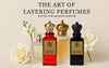 Three perfume bottles with gold crowns and flowers on a beige background, promoting 'The Art of Layering Perfumes' by Royale Noir.