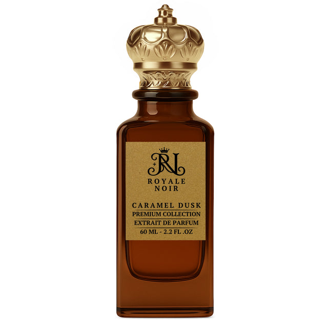 Caramel Dusk Extrait De Parfum Premium Collection by Royale Noir – Elegant Fragrance in Transparent Brown Bottle With Gold Label And Gold Crown Cap.