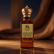Perfume bottle labeled 'Royale Noir caramel dusk' with a gold cap on a reflective surface.